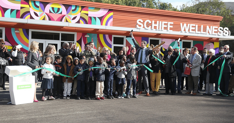 A group of children, teachers, and providers celebrate the opening of a school-based dental center at the Academy of World Languages, part of the Cincinnati Public School district.