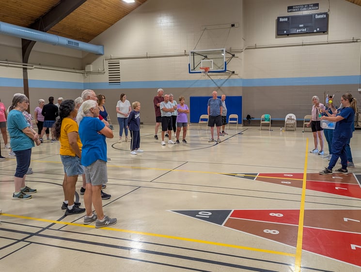 The Smiles on Wheels team starts an educational session before a group fitness class.